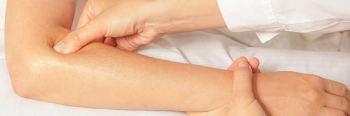tuina massage performed on arm and elbow