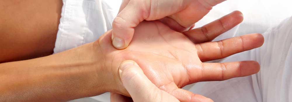 tuina massage performed on palm of the hand